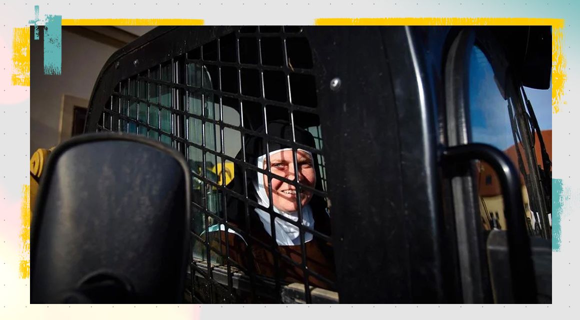 Nun smiling in their skid steer loader