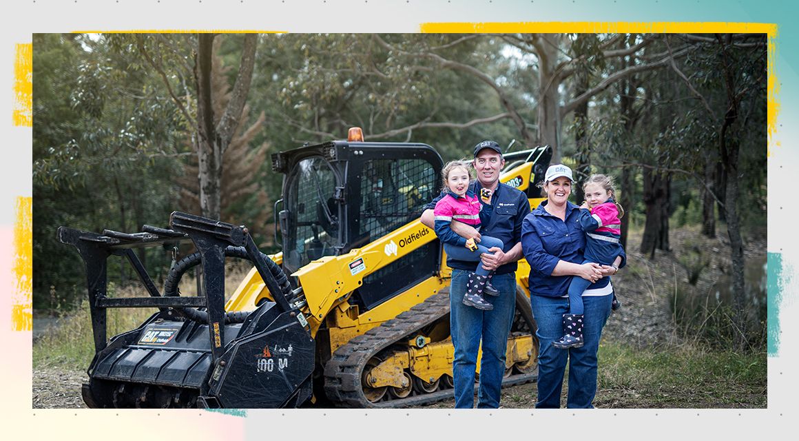 Oldfields family standing in front of a Cat machine