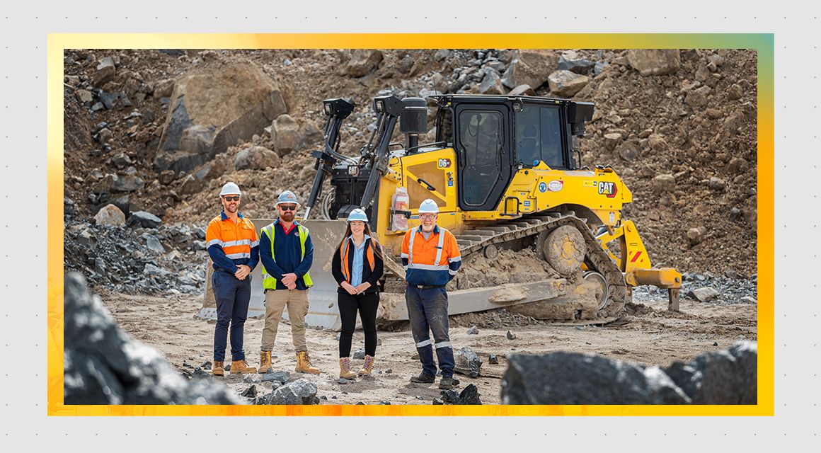 Divall earthmover team standing in front of a D6 dozer