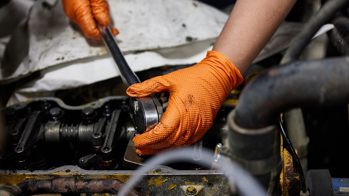 Man replacing a Cat Filter on engine