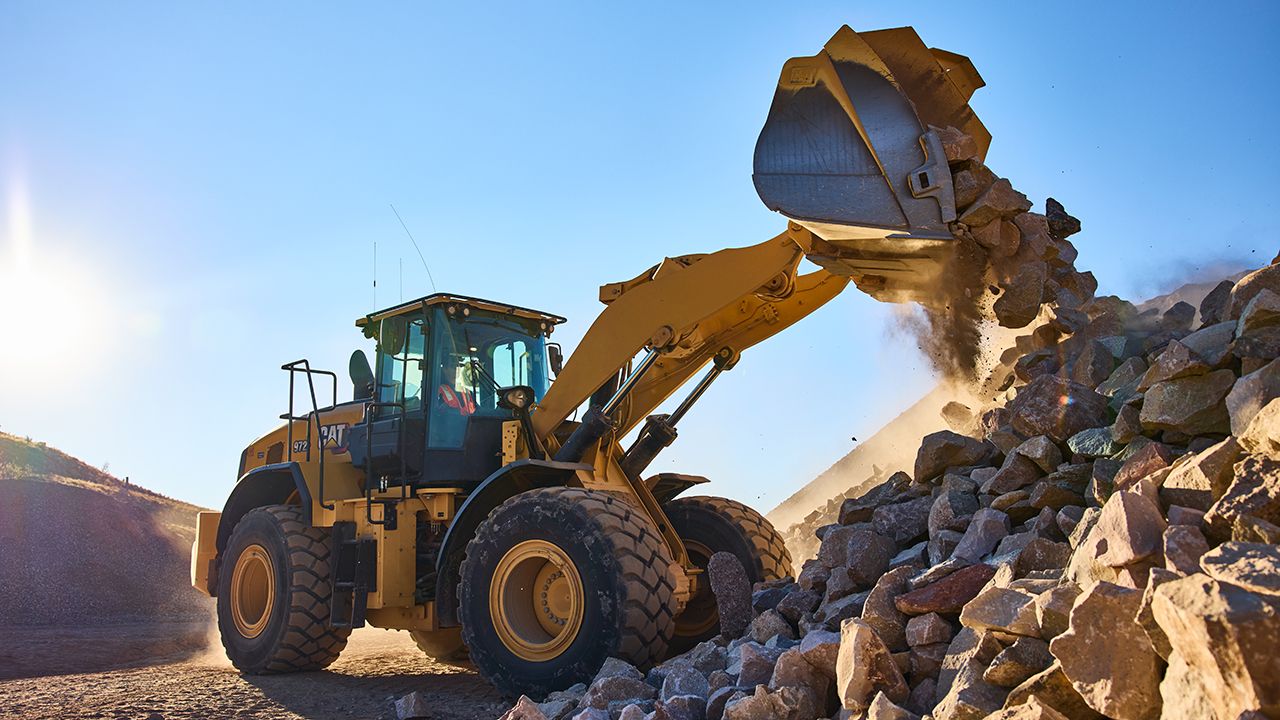 Cat equipment dumping rocks
