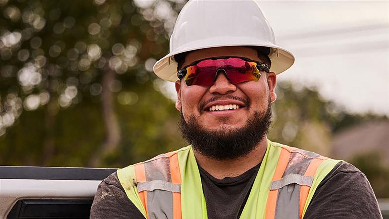 Man Servicing hose on a mini excavator