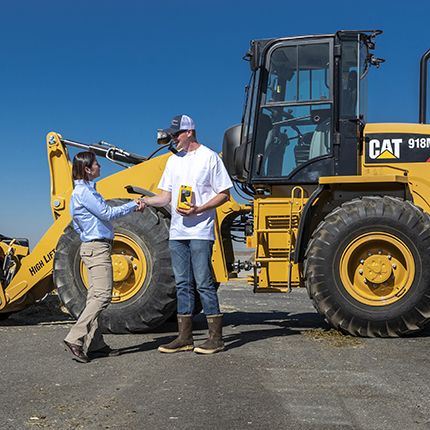 Cat dealer shaking hands with customer