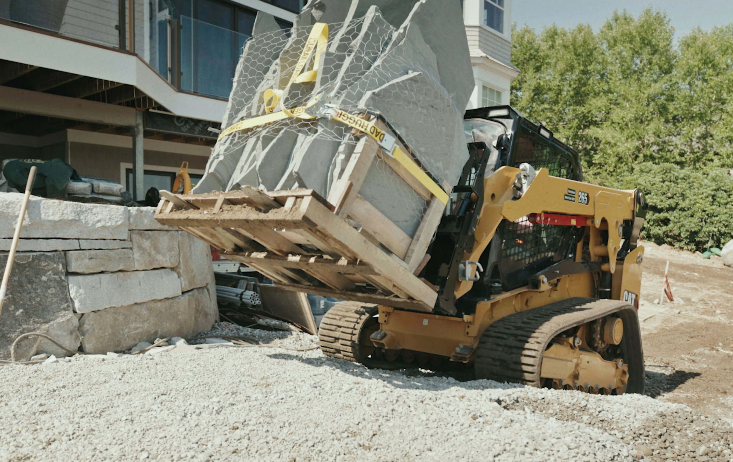 Skid steer hauling slabs of concrete