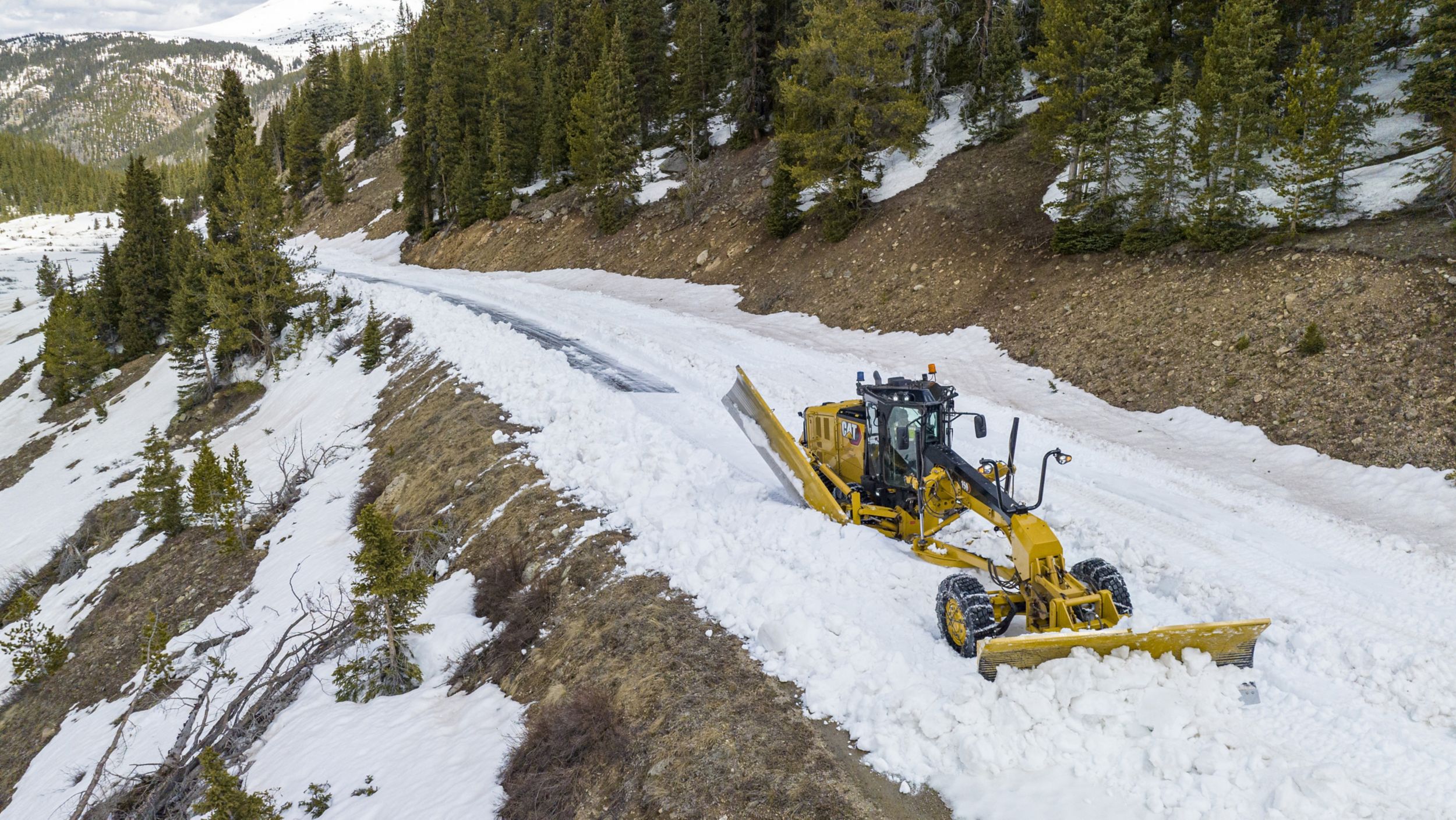 Cat dealer talking to customer about Cat Credits in a corn field