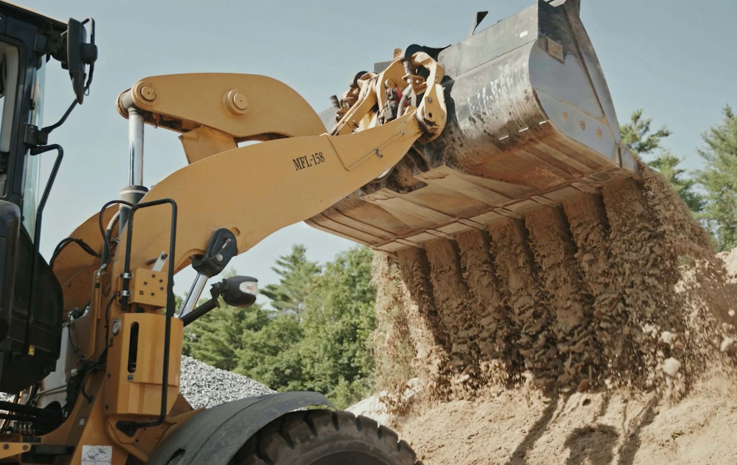 Wheel loader dropping dirt