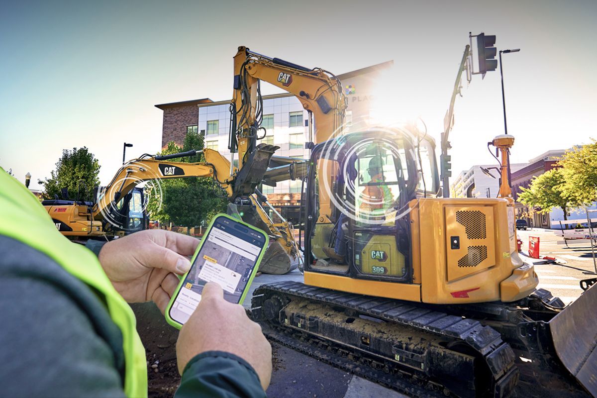 Construction manager using VisionLink® on tablet to monitor mixed fleet performance.