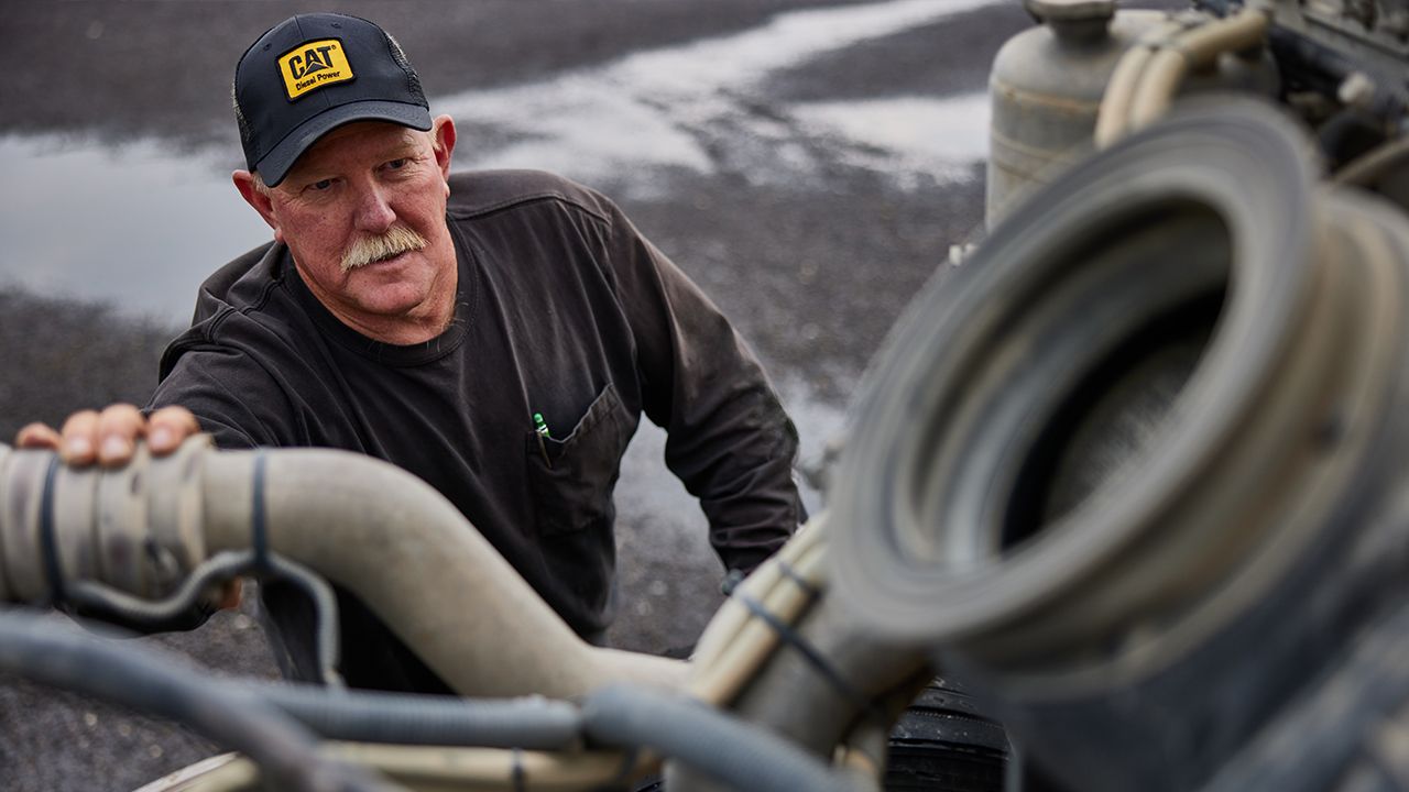 a Cat truck engine being inspected