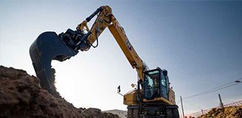 M319 Cat wheeled Excavator moving dirt on jobsite