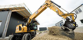 315 Cat Excavator moving dirt on jobsite