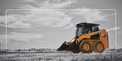 Skid steer moving dirt