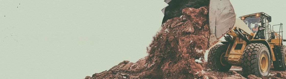 wheel loader on site scooping up some dirt