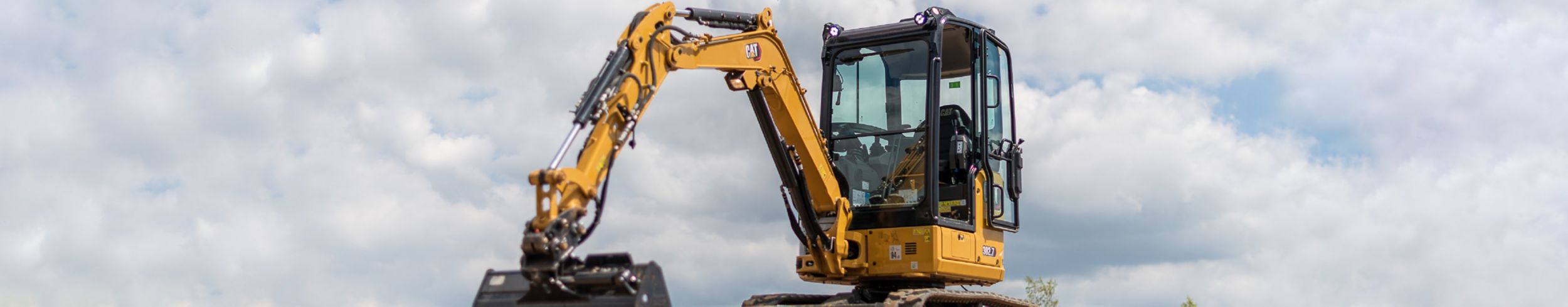 Mini excavator parked on a hill