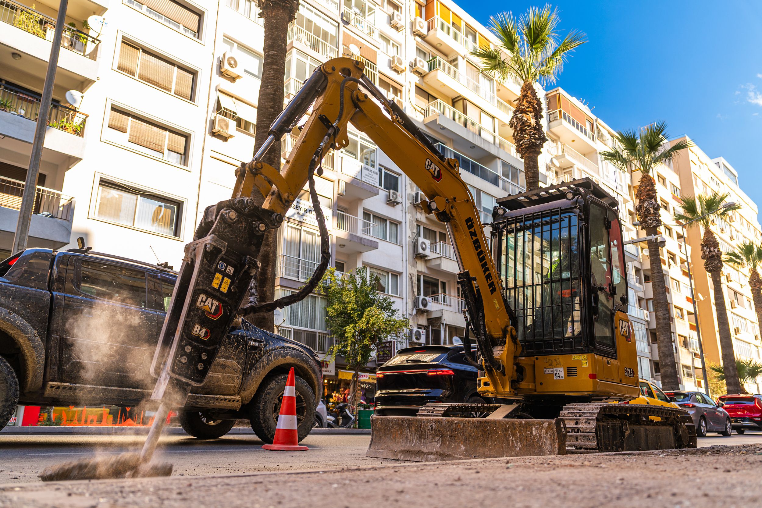 Mini excavator working on a sidewalk