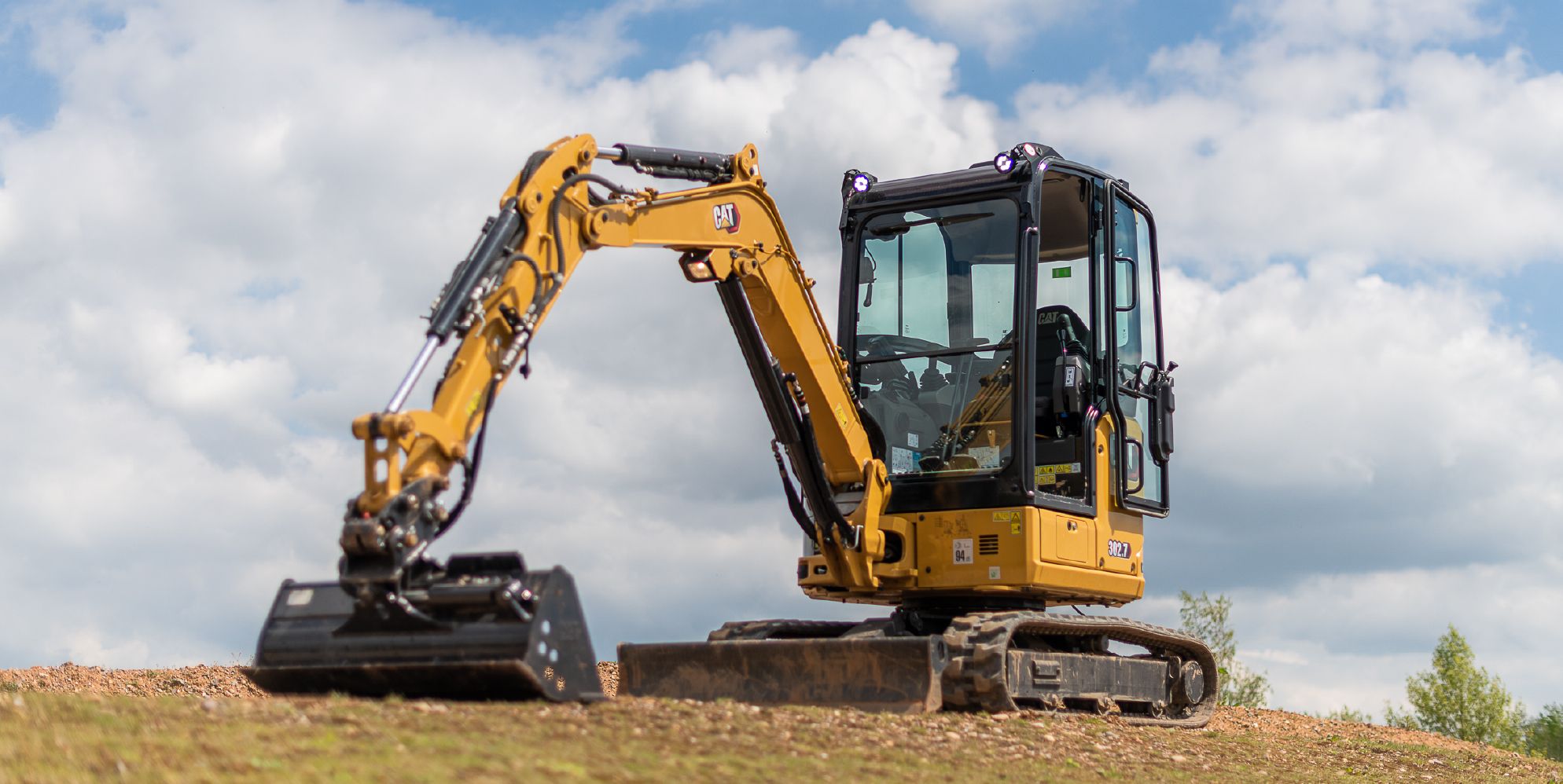 Mini excavator on a hill (showing work lights)