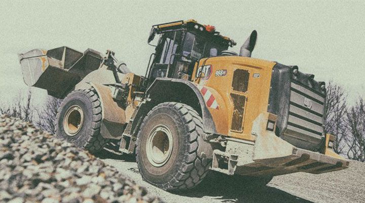 wheel loader on site scooping up some dirt