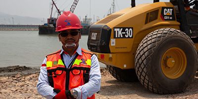 Man standing in front of CAT equipment