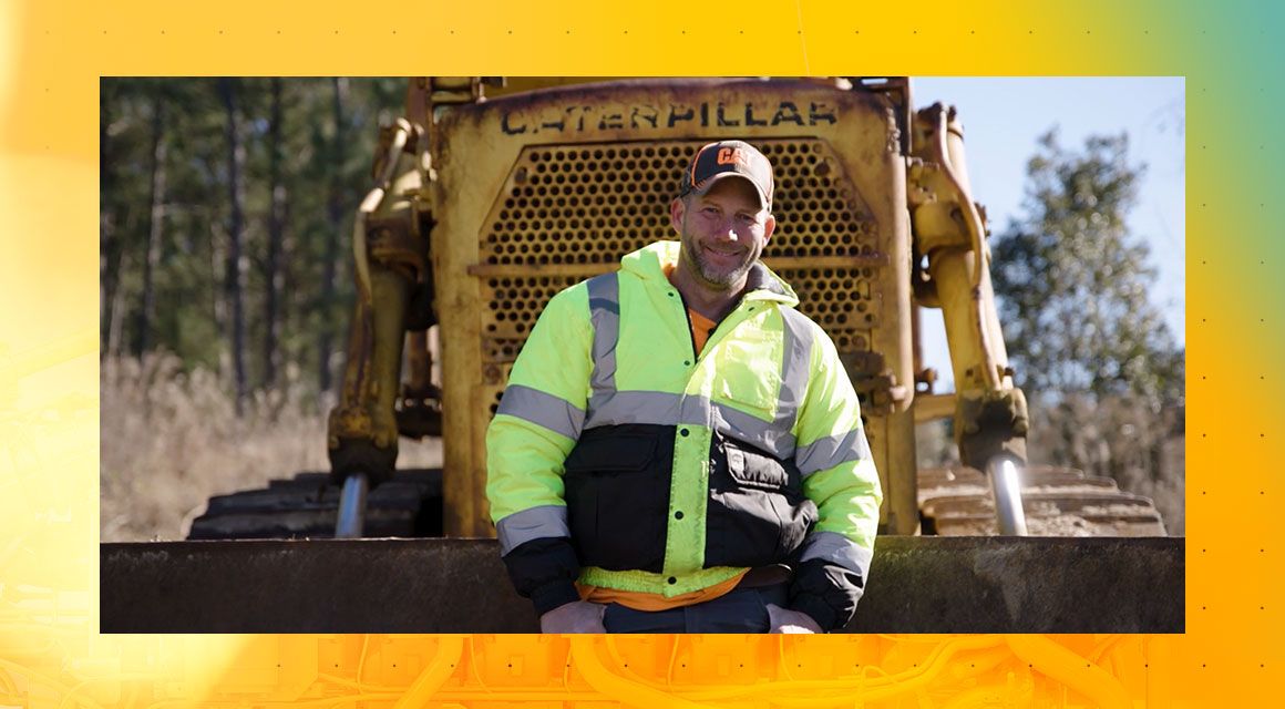 Kurt Edwins standing in front of a Cat machine