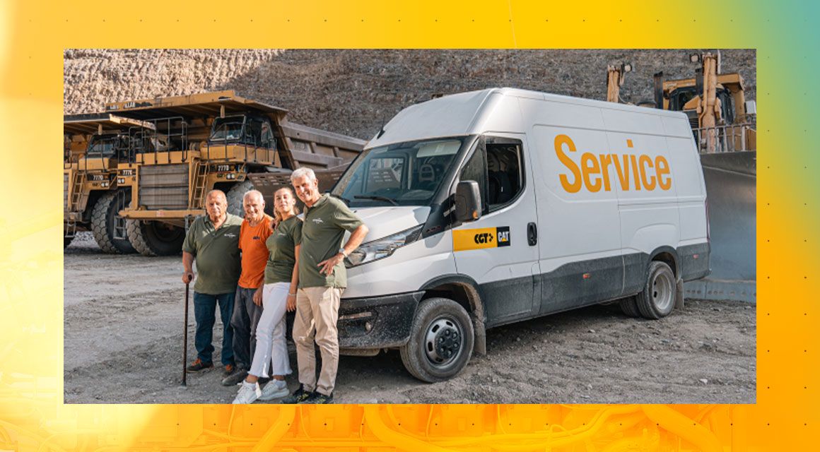 Group photo in front of a Cat service vehicle