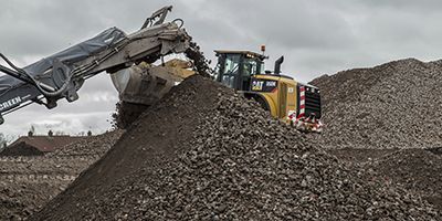 Cat machine dumping rocks