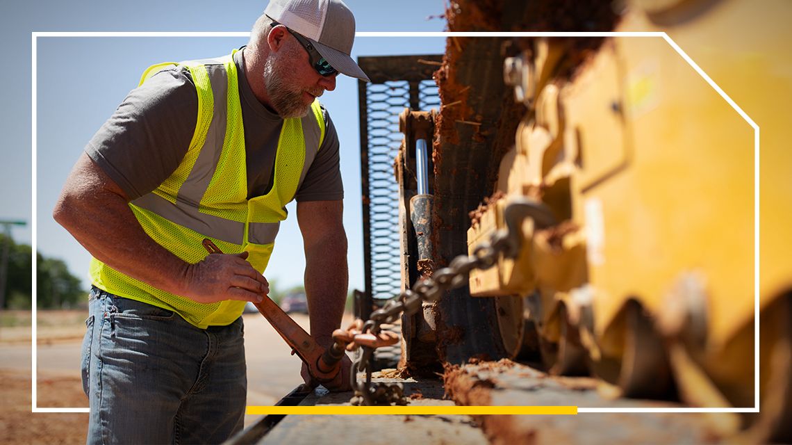 Man Servicing hose on a mini excavator
