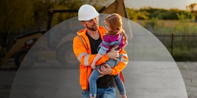 Man with daughter in front of Cat machine