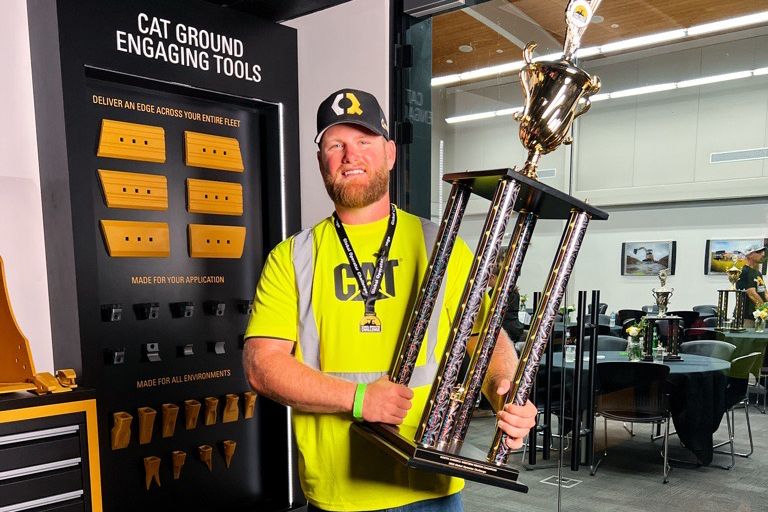 Brock Lecler, AmN Regional Winner, holding their trophy