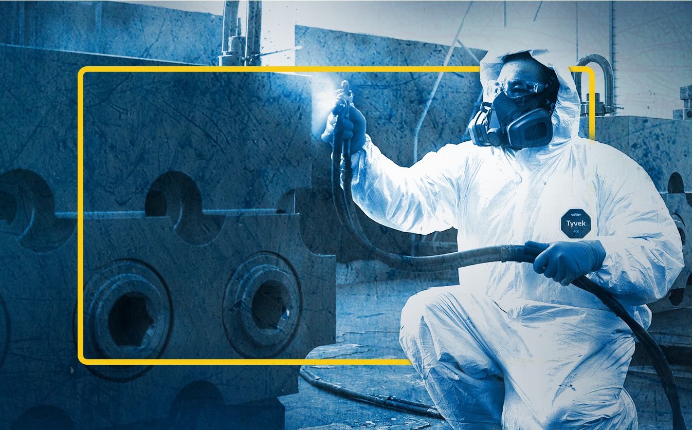 SPM employee spray painting part in SPM service center