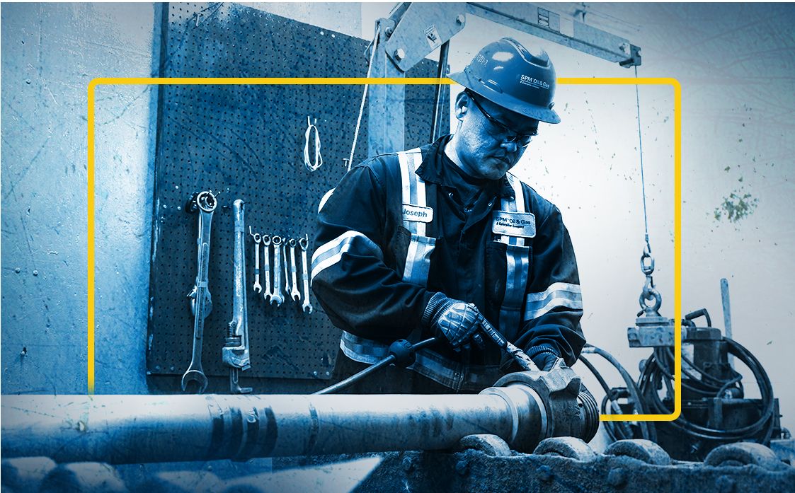 employee working on equipment in SPM service center