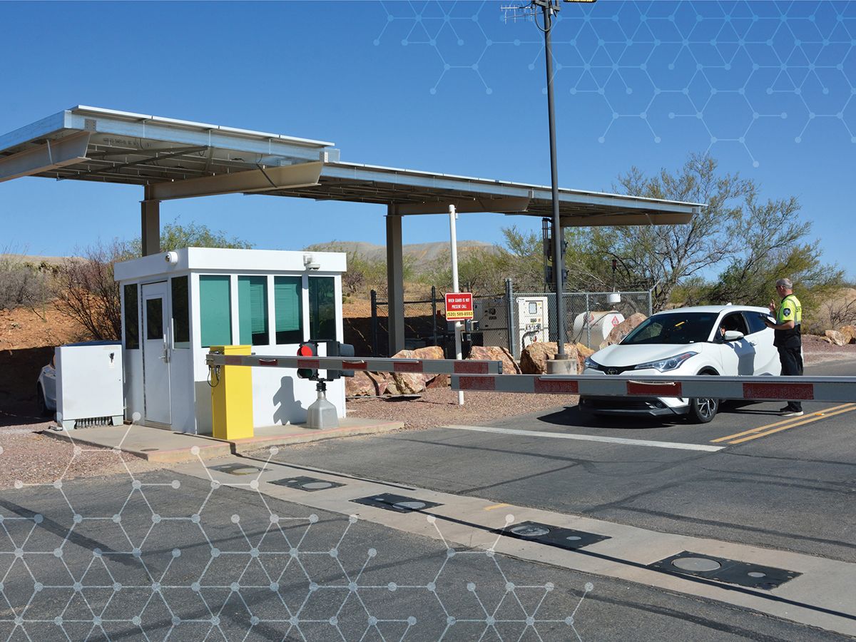 TPG gatehouse showing a guard speaking to a person in a car