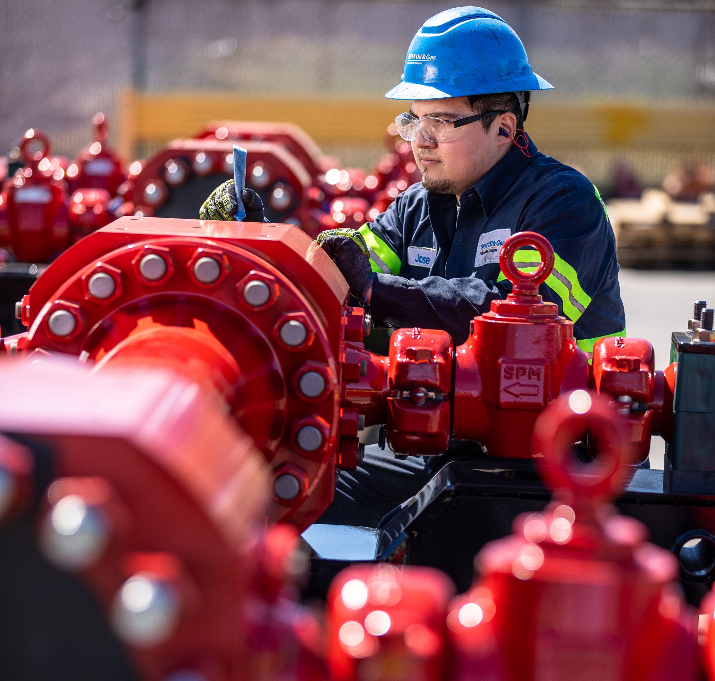 Service technician maintaining oilfield machinery