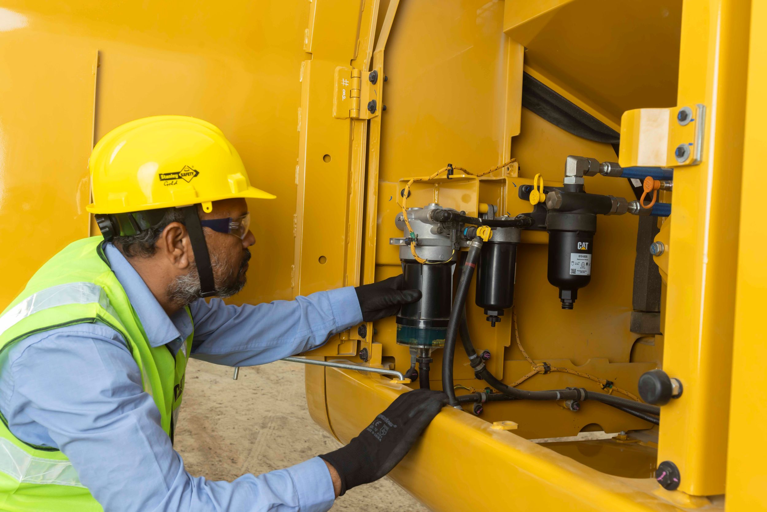Operator climbing into an excavator to do the work with VisionLink.