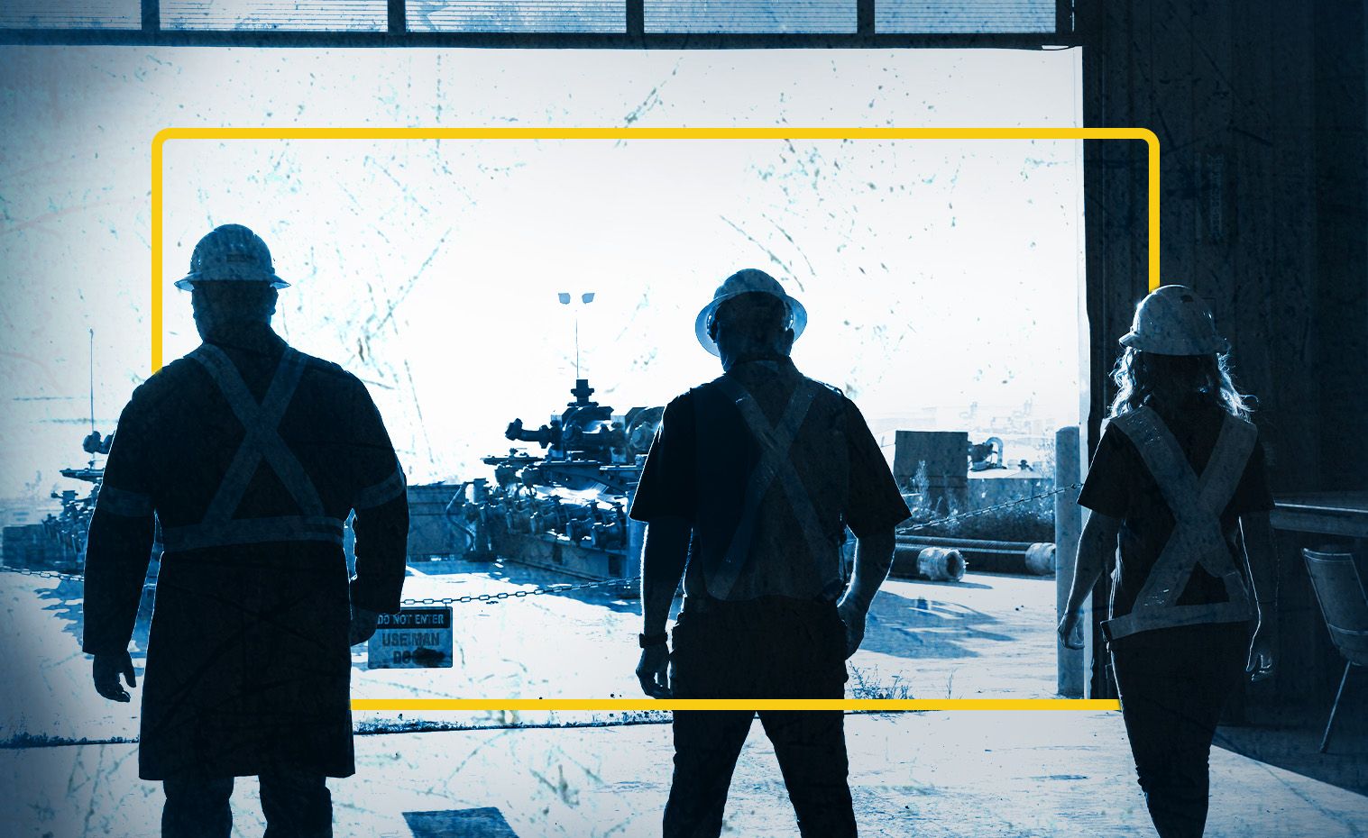 Three SPM employes walk towards the exit of the warehouse