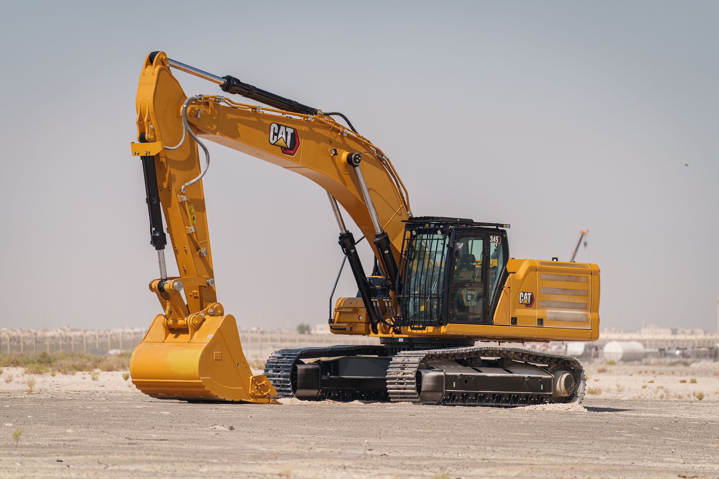 Cat® 345 hydraulic trackhoe excavators bring premium power, performance, control, digging, trenching, and heavy lifting capacity to your large scale projects.