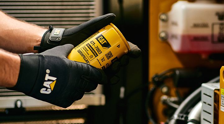 Technician holding a transmission oil filter