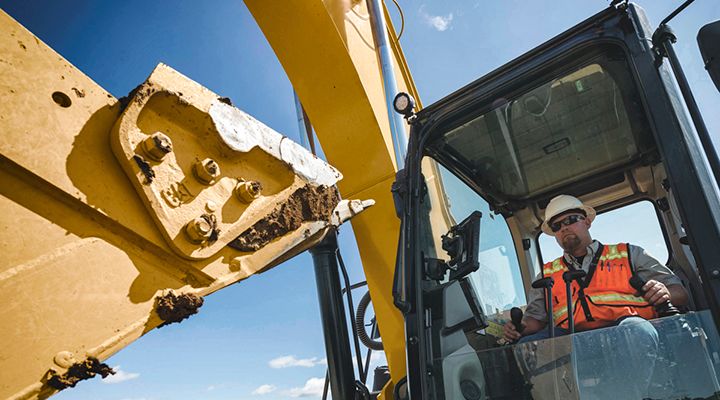 Close up of side cutter on the bucket of a 320 Excavator