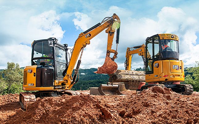 miniescavadeiras em pilha de terra