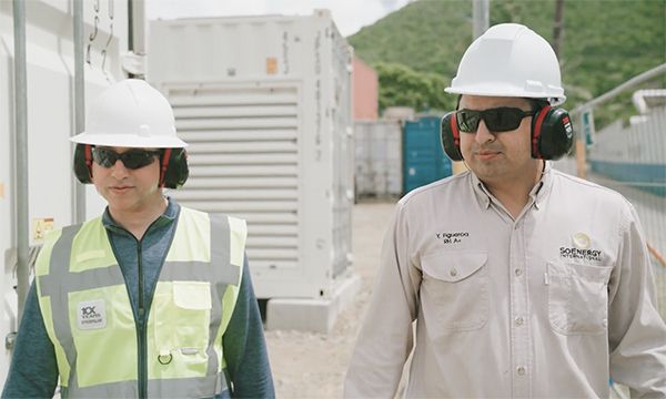 Female employee and male employee walking at the St. Maarten facility