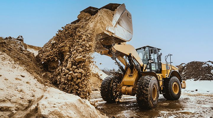 Cat 950 GC Wheel Loader empties sand at quarry