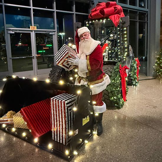 santa claus standing in front of a machine