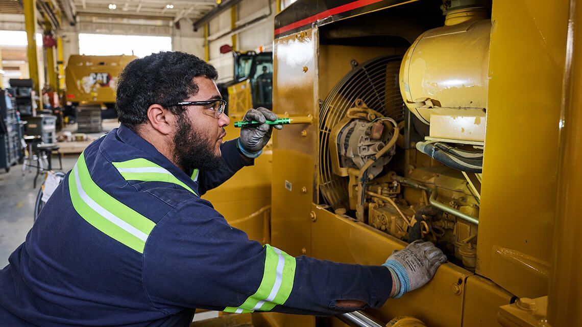 technician iinspecting a machine