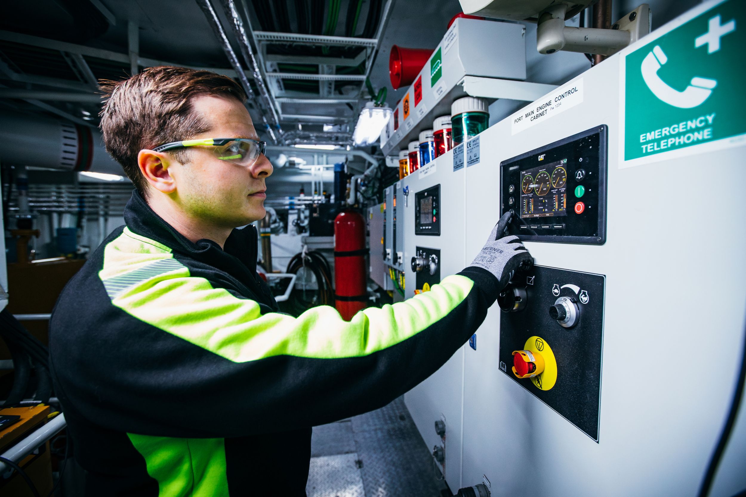 Person working on a main control cabinet in an tug engine room