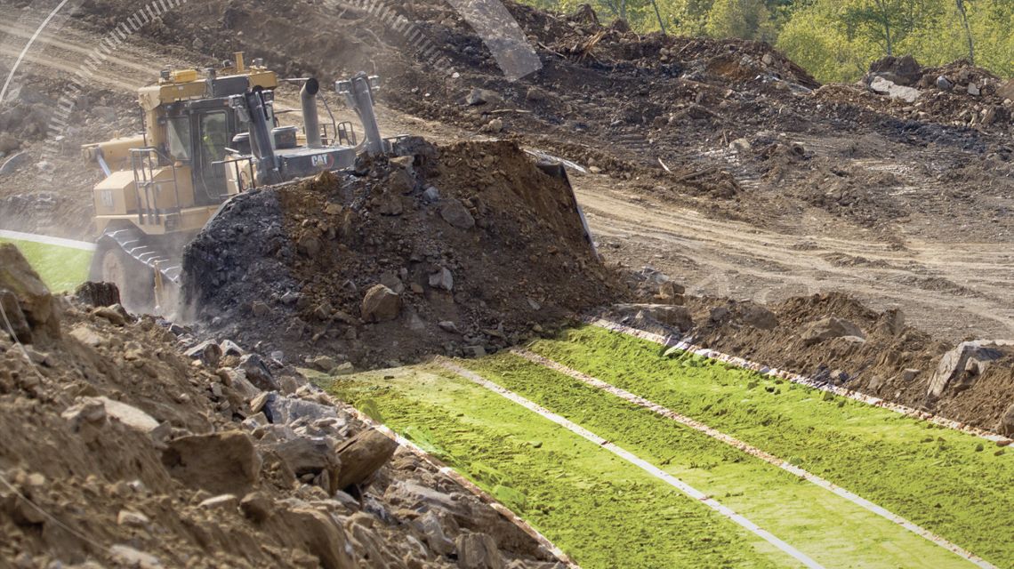 Dozer using technology to maintain grade