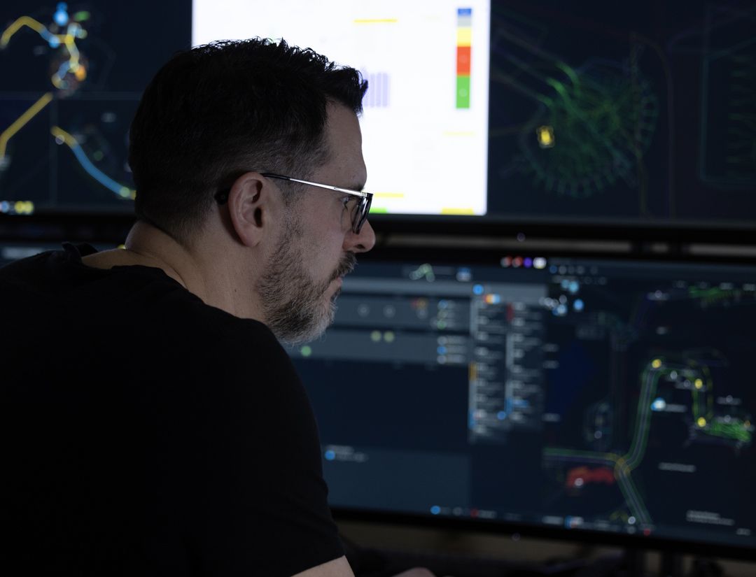 Man studying screens reporting data