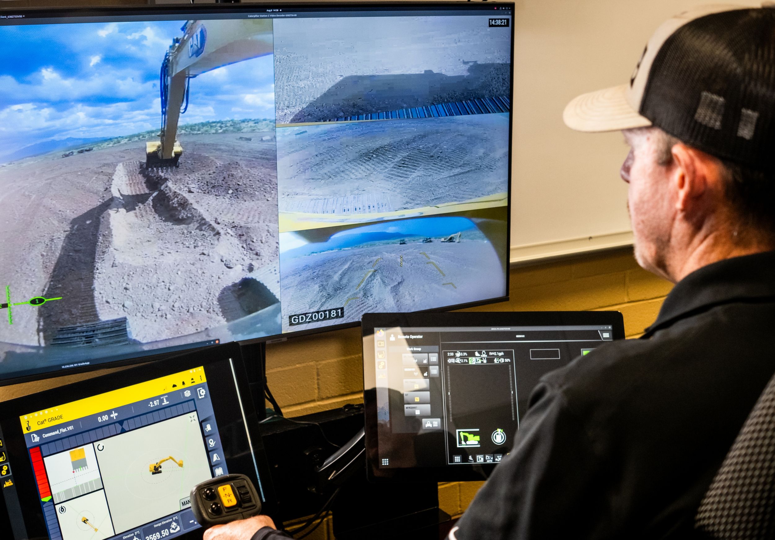 Operator using a remote station to control an excavator