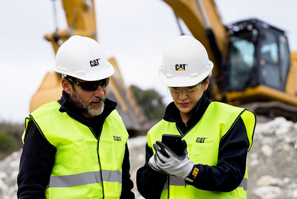 Workers reviewing data on digital device