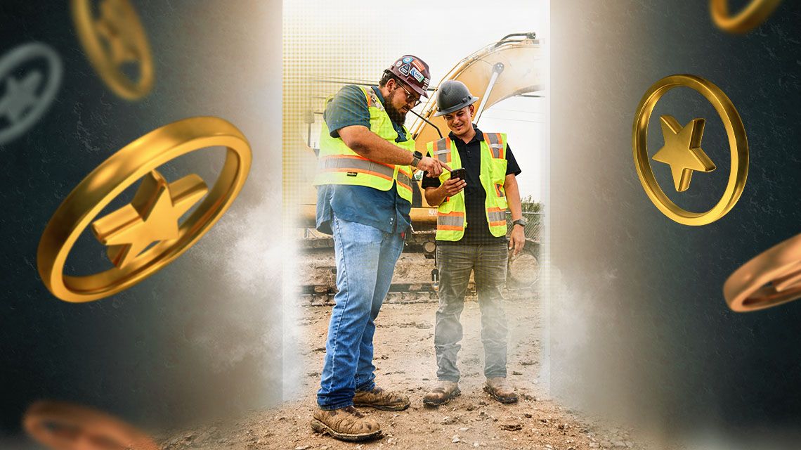 Two cat workers inspecting mobile device