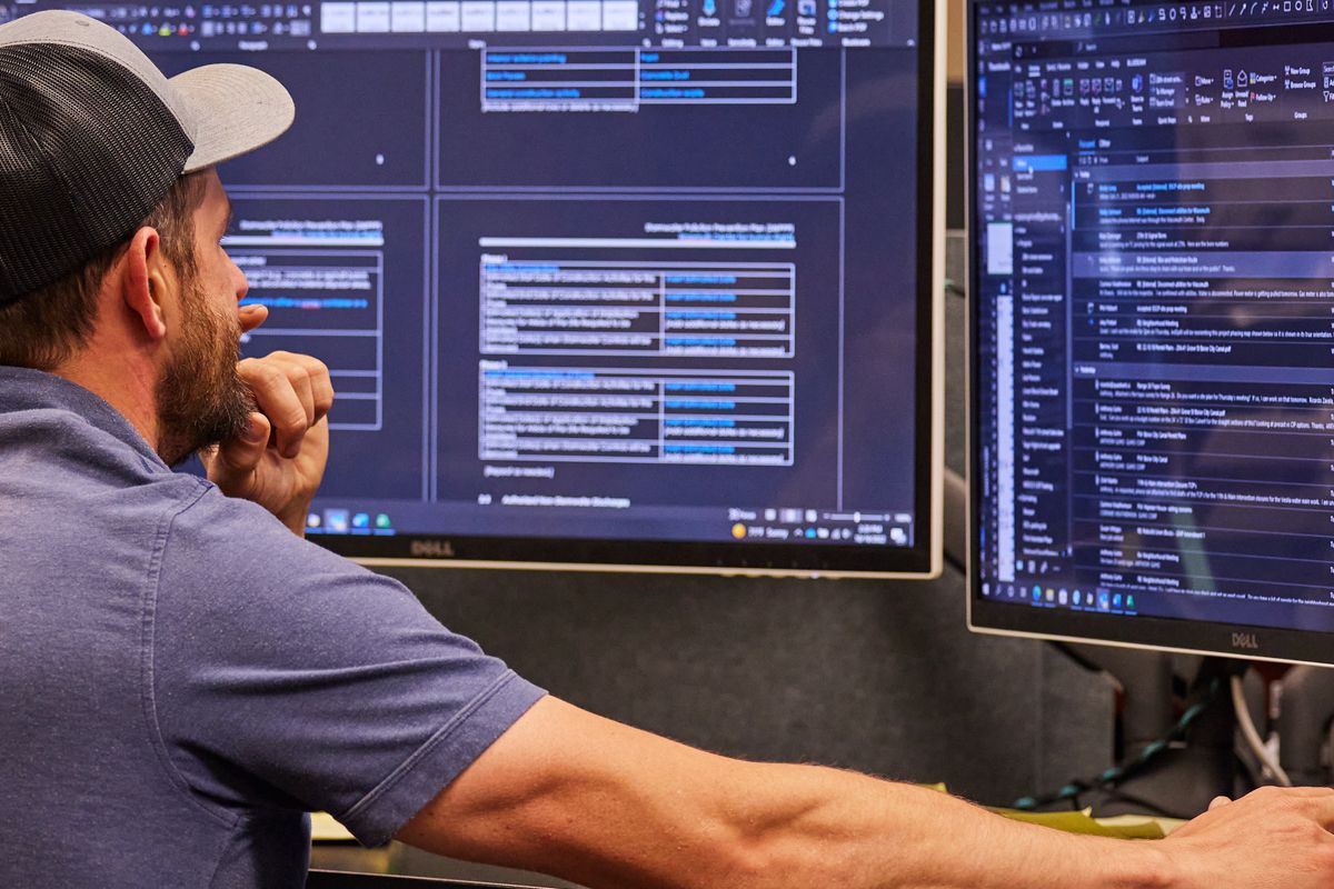Person sitting at a desk reviewing VisionLink® data