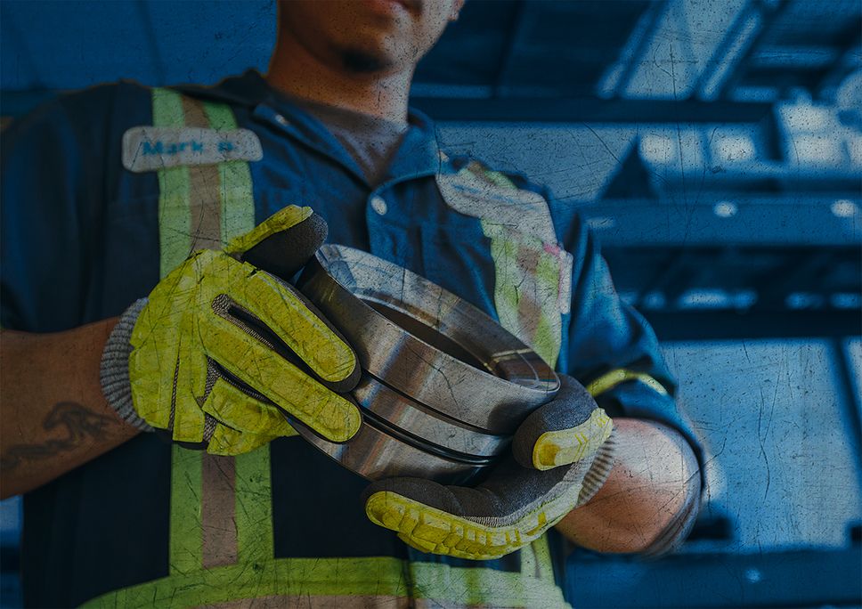 SPM employee holding a SPM part