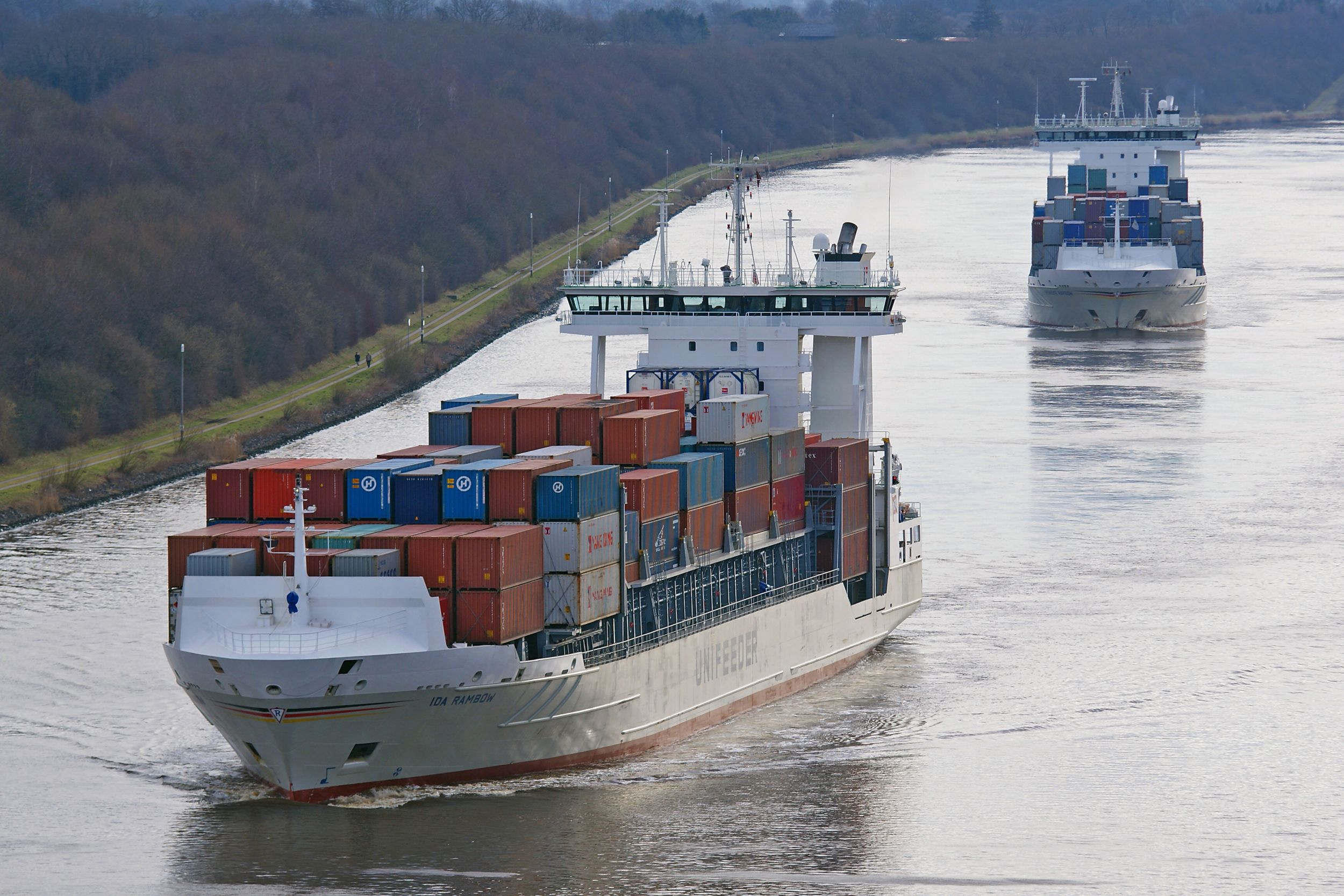 Rambow cargo ships navigating through a river